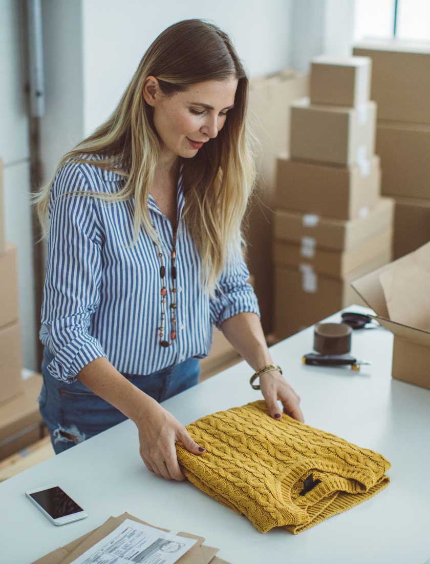 small business owner packing products for shipment to customer